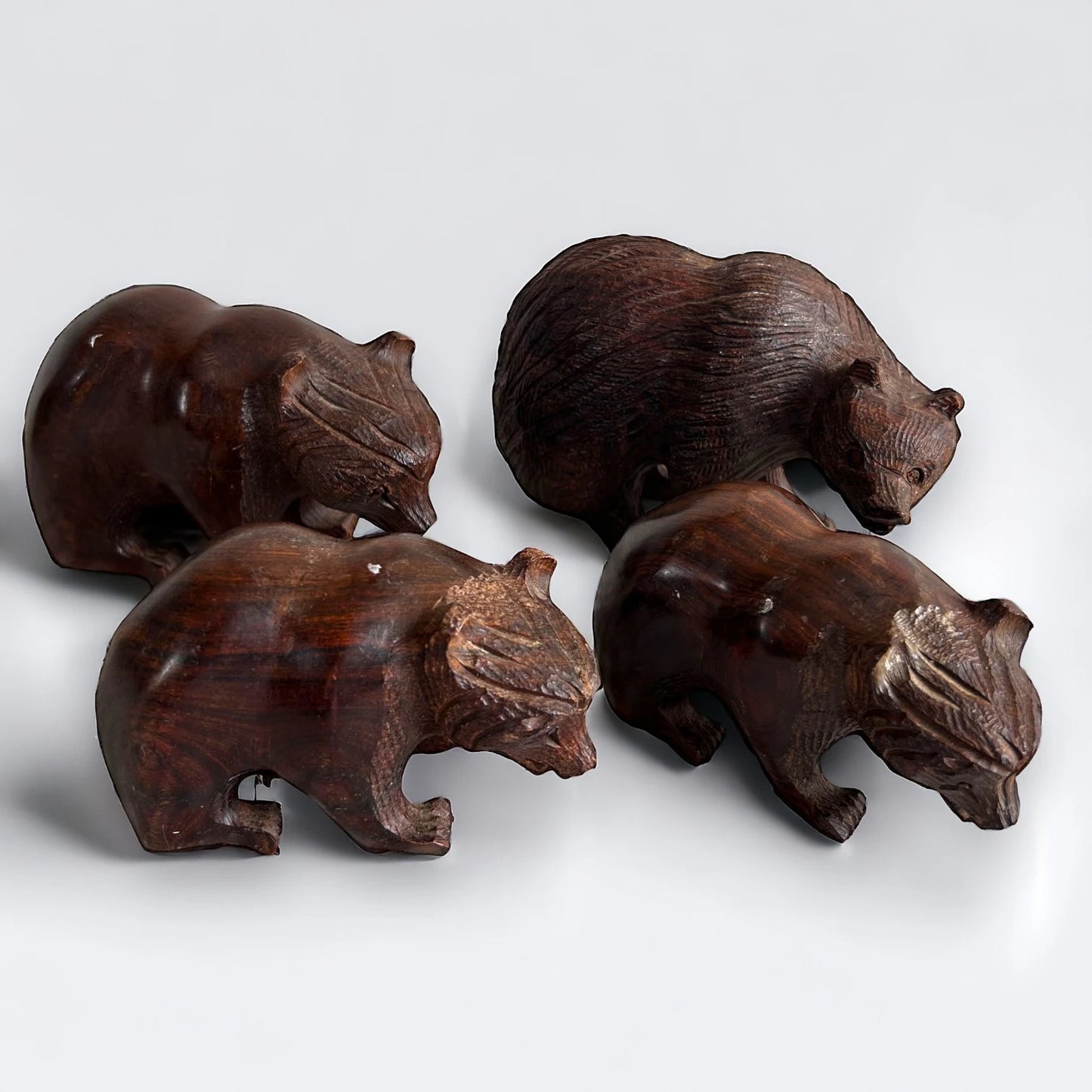 Mid century set of four dark wood bear statues
