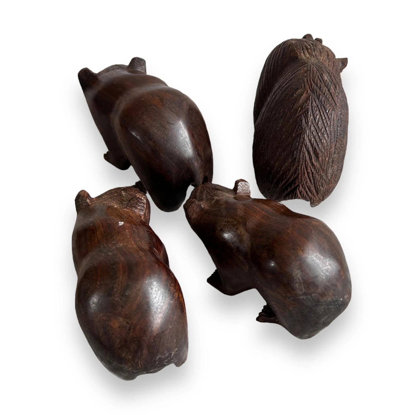 Mid century set of four dark wood bear statues