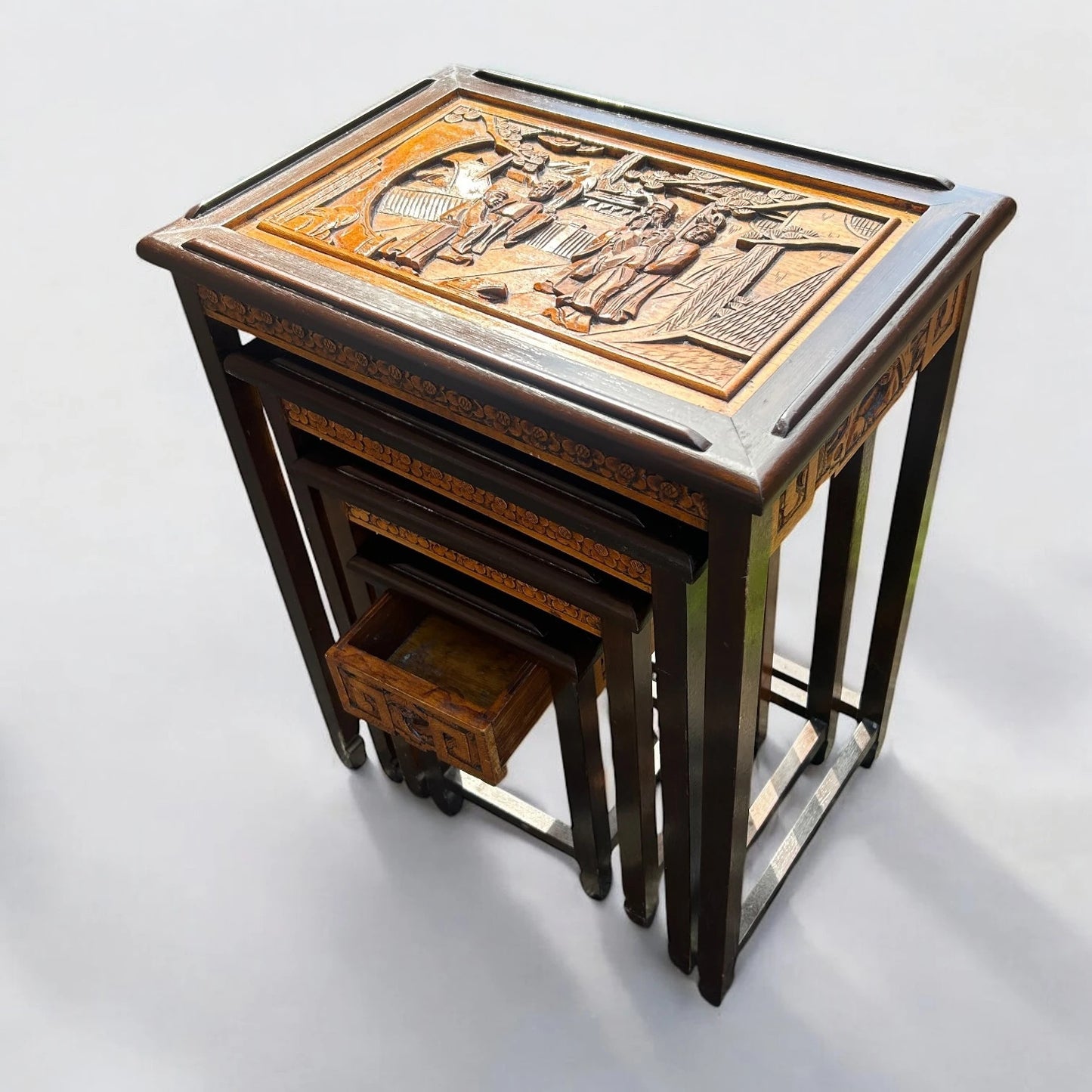 Antique Chinese Camphor Wood Nest of Four Tables with Hand-Carved Panels