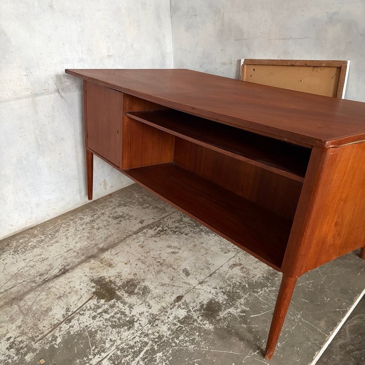 Rear storage shelves and lockable cupboard on mid-century teak desk