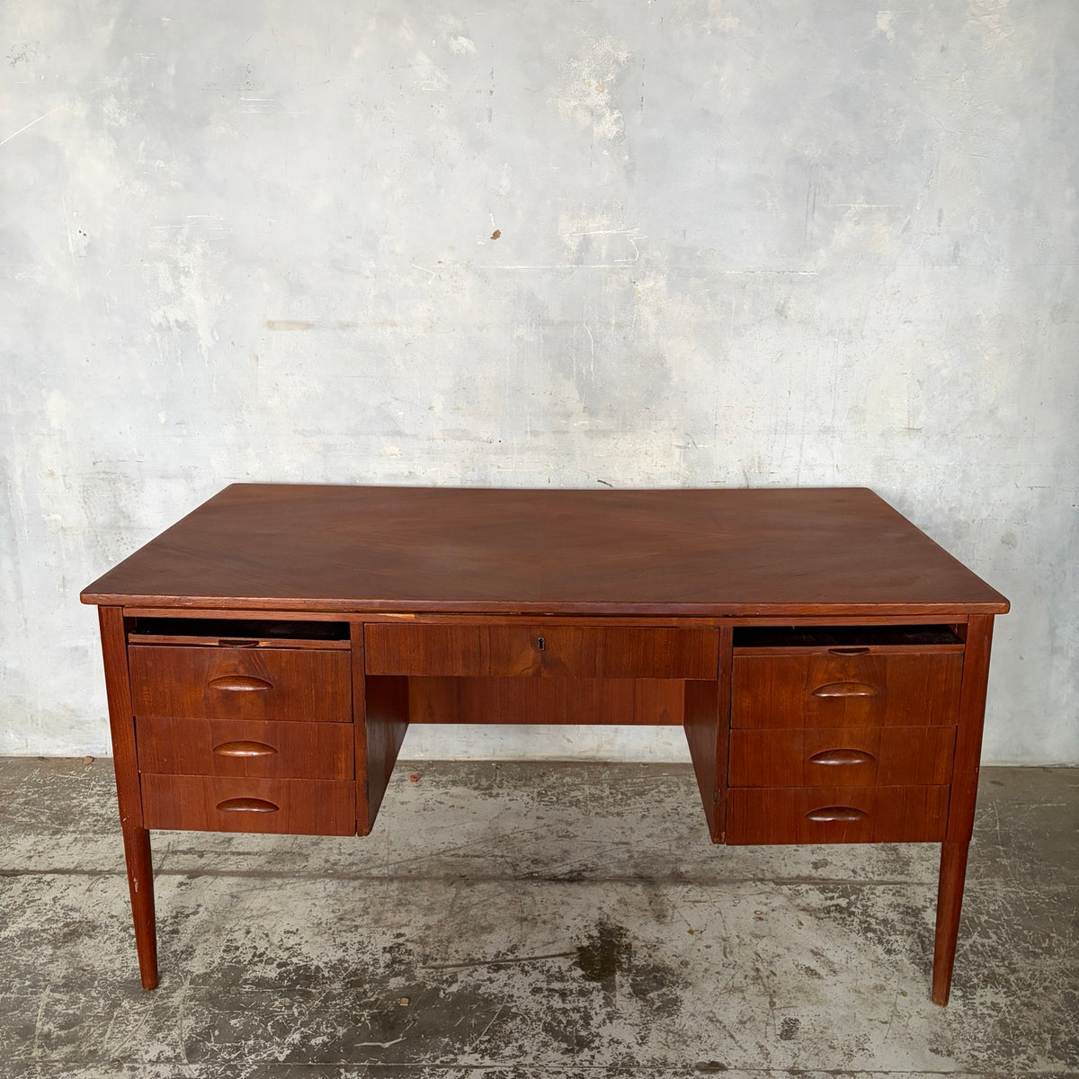 Mid-century teak executive desk viewed from the front