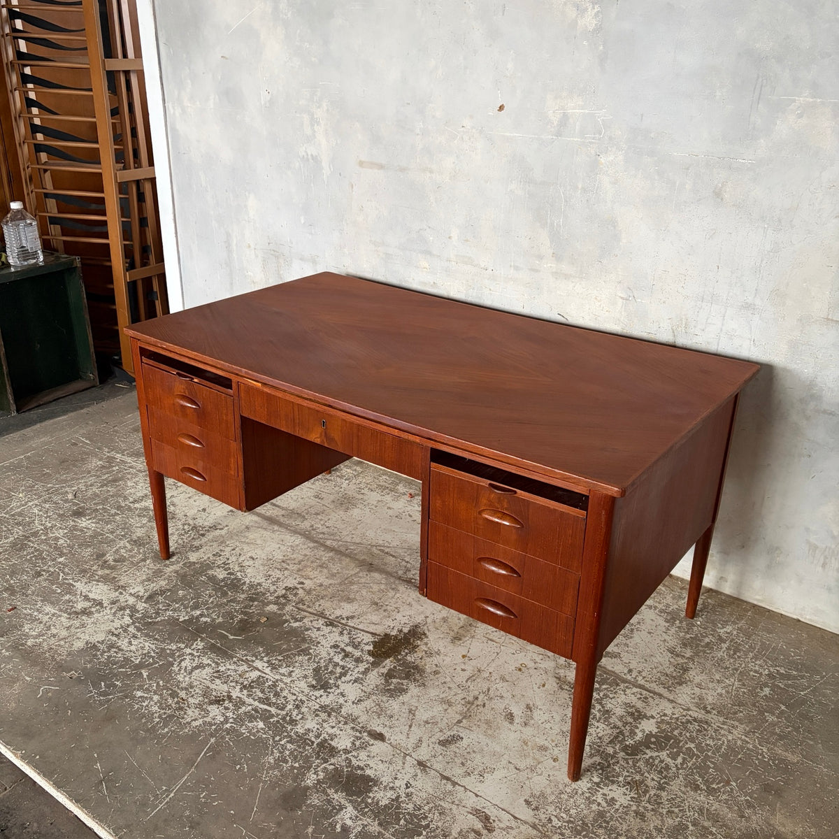 Danish teak twin pedestal desk showing the refinished patterned desktop