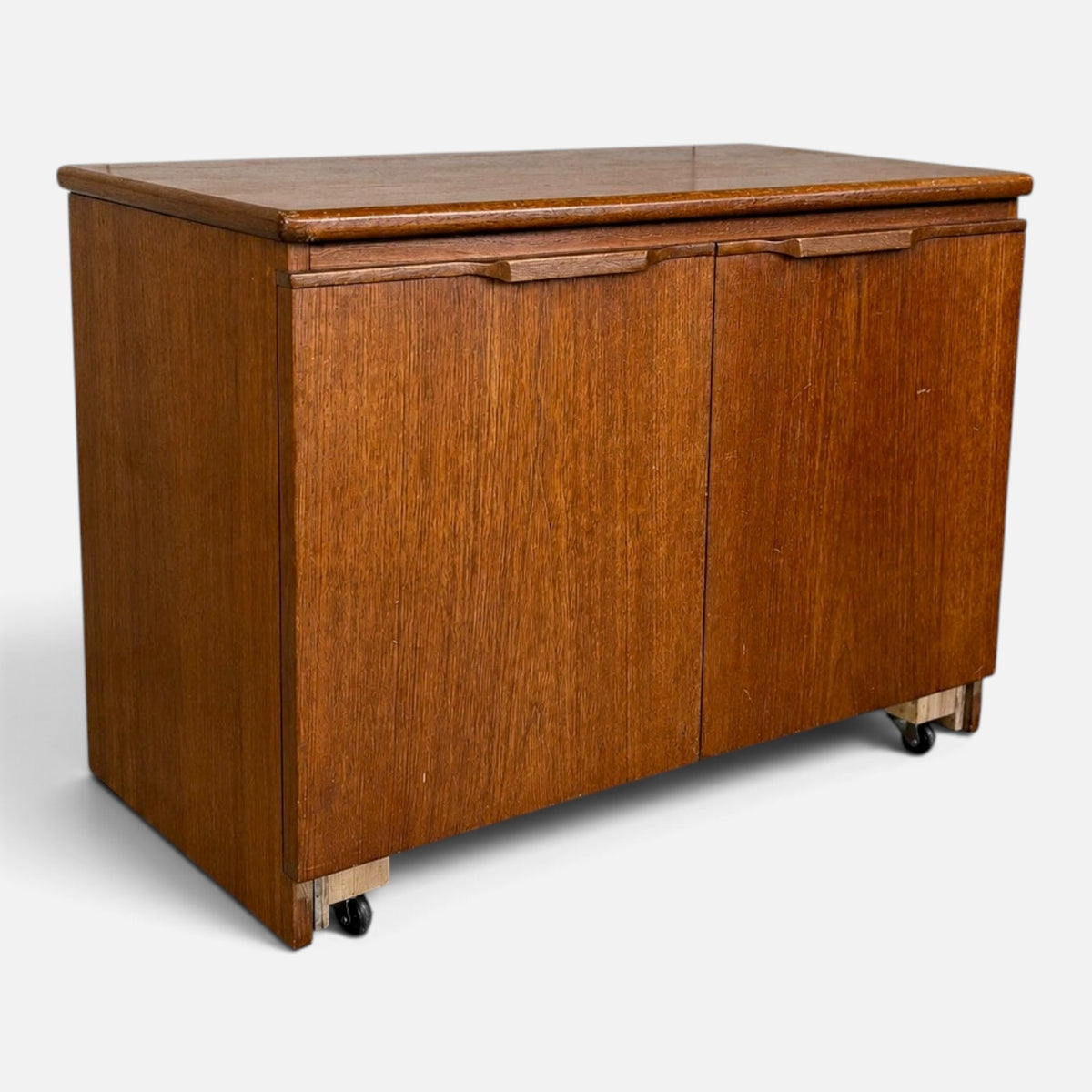 Mid-century teak two-door storage cabinet on castors – photograph 2