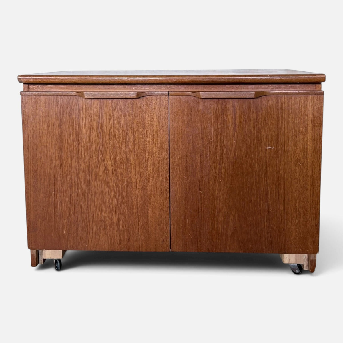 Mid-century teak two-door storage cabinet on castors – photograph 3
